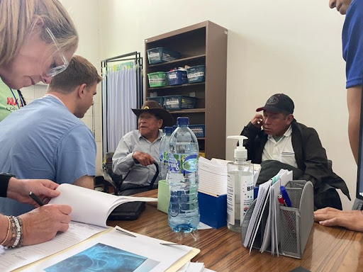 Operation Walk clinicians meeting with Guatemalan patients during a bedside consultation