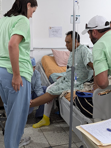 A recovering Guatemalan patient beginning to stand and move with help from the Operation Walk team