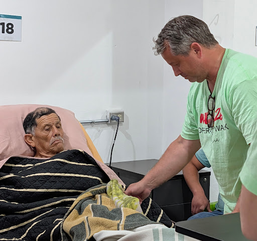 An Operation Walk volunteer checking on a Guatemalan patient at the bedside