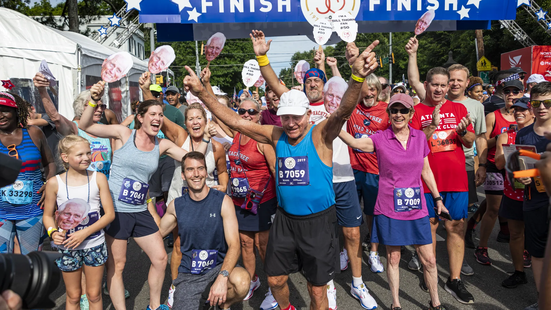 Happy Peachtree Road Race finishers celebrating after the race